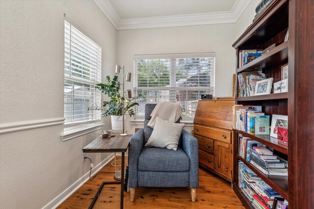 104 Lost Oaks Dr, Waco, TX 76705 - living area with healthy amount of natural light, a textured wall, crown molding, light wood-style flooring, and baseboards