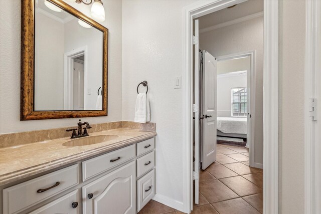 104 Lost Oaks Dr, Waco, TX 76705 - ensuite bathroom with ornamental molding, tile patterned flooring, vanity, and baseboards