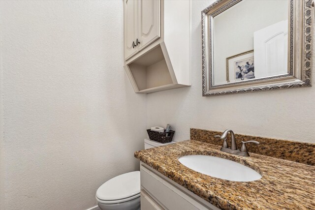 104 Lost Oaks Dr, Waco, TX 76705 - bathroom with toilet, vanity, and a textured wall