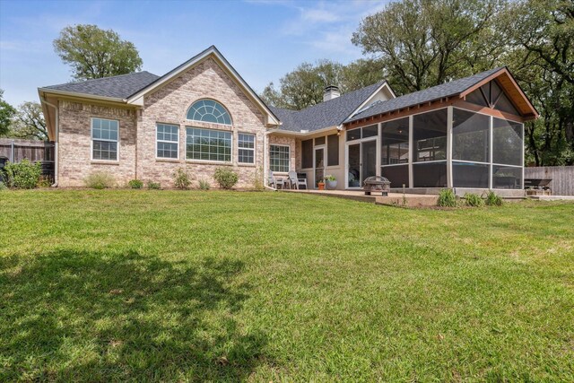 104 Lost Oaks Dr, Waco, TX 76705 - back of house with a sunroom, a chimney, a shingled roof, and brick siding