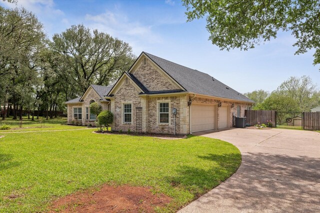 104 Lost Oaks Dr, Waco, TX 76705 - view of front of property featuring driveway, central AC, an attached garage, brick siding, and a shingled roof