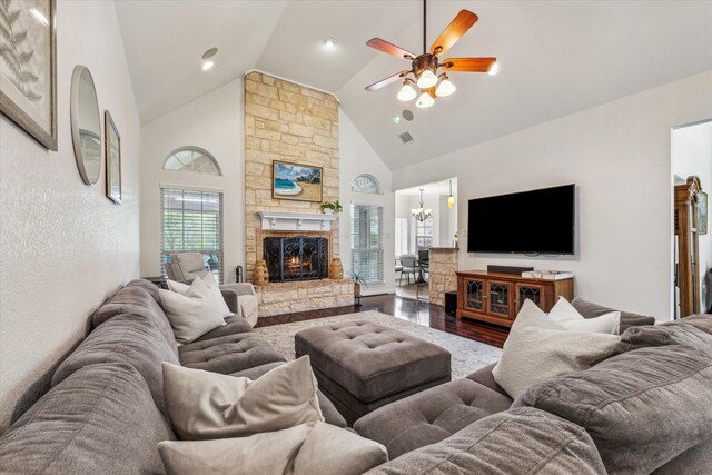 104 Lost Oaks Dr, Waco, TX 76705 - living area featuring wood finished floors, a ceiling fan, high vaulted ceiling, a stone fireplace, and a chandelier