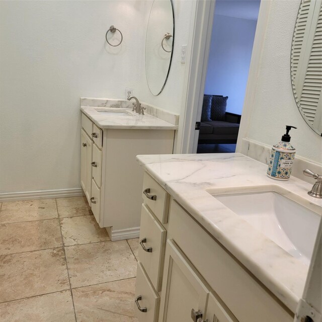15642 Overmead Cir, Dallas, TX 75248 - bathroom with two vanities and baseboards