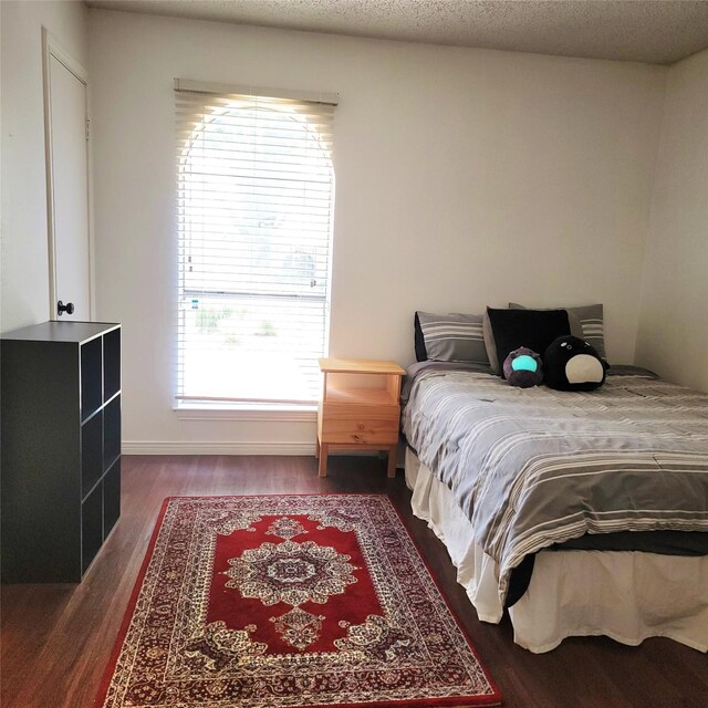 15642 Overmead Cir, Dallas, TX 75248 - bedroom with dark wood-style flooring, multiple windows, and baseboards