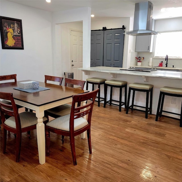15642 Overmead Cir, Dallas, TX 75248 - dining area with light wood finished floors, recessed lighting, and a barn door