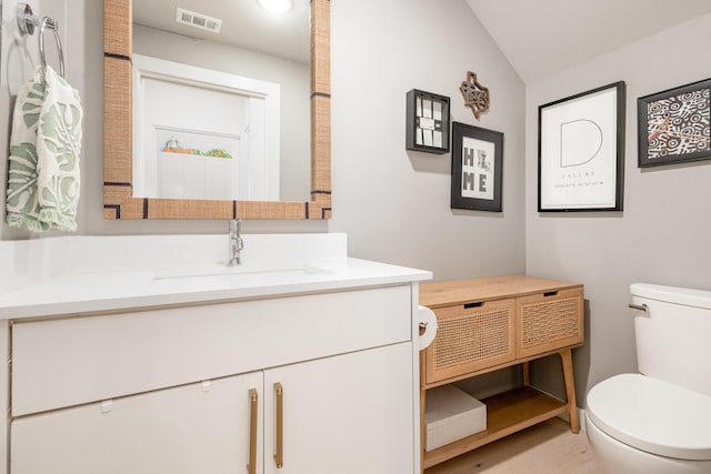 427 W 10th St Unit 803, Dallas, TX 75208 - half bathroom featuring toilet, vanity, and vaulted ceiling