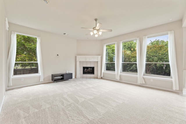 1928 Victoria Cir, Mckinney, TX 75072 - unfurnished living room with plenty of natural light, ceiling fan, carpet floors, and a fireplace