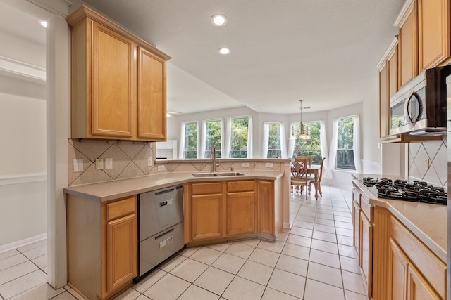 1928 Victoria Cir, Mckinney, TX 75072 - kitchen with a sink, appliances with stainless steel finishes, backsplash, light countertops, and recessed lighting