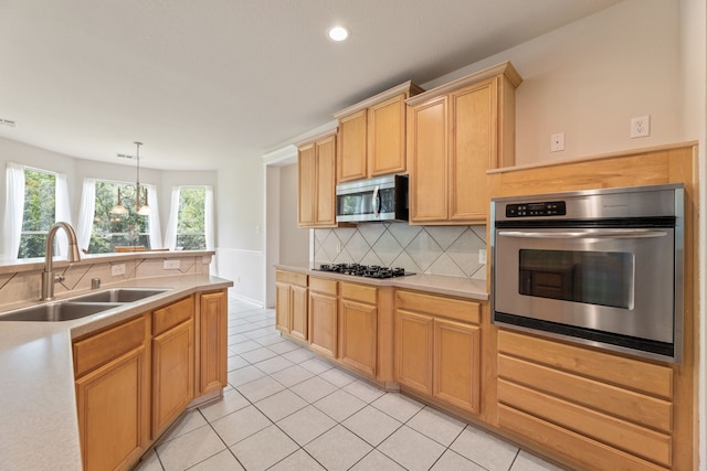 1928 Victoria Cir, Mckinney, TX 75072 - kitchen featuring appliances with stainless steel finishes, a sink, light countertops, tasteful backsplash, and recessed lighting