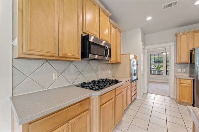 1928 Victoria Cir, Mckinney, TX 75072 - kitchen featuring stainless steel appliances, light countertops, light tile patterned flooring, backsplash, and recessed lighting