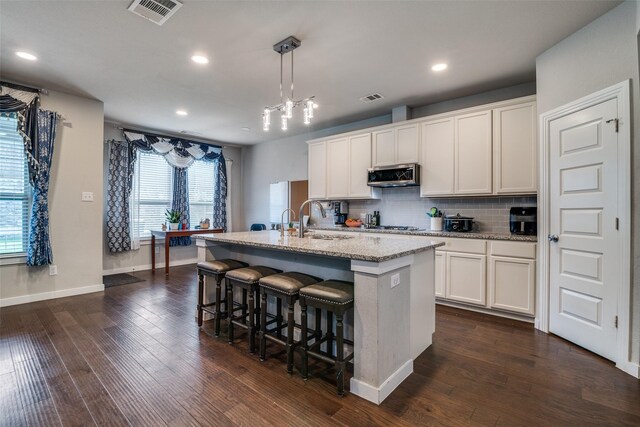 1822 Indigo Creek Ln, Wylie, TX 75098 - kitchen with appliances with stainless steel finishes, a sink, an island with sink, decorative backsplash, and recessed lighting