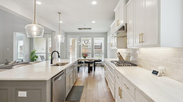 4190 Sandhills Ln, Prosper, TX 75078 - kitchen with a sink, appliances with stainless steel finishes, under cabinet range hood, recessed lighting, and light wood-style floors