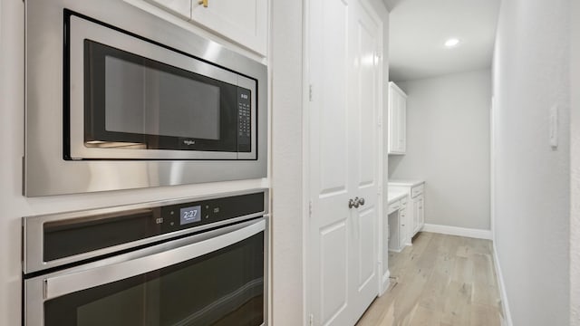 4190 Sandhills Ln, Prosper, TX 75078 - kitchen featuring appliances with stainless steel finishes, light wood-type flooring, white cabinetry, baseboards, and light countertops