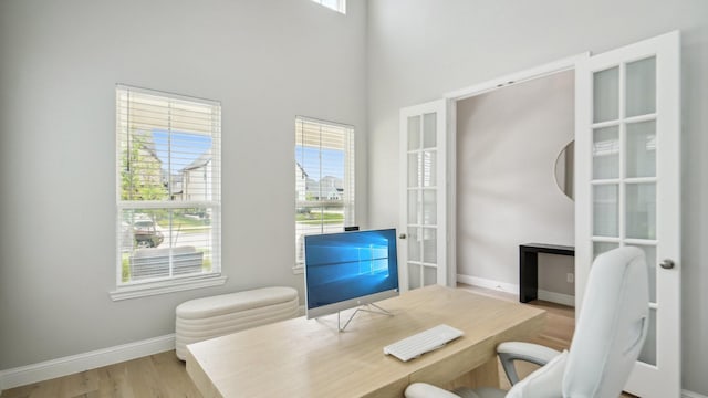 4190 Sandhills Ln, Prosper, TX 75078 - office featuring wood finished floors, baseboards, and a towering ceiling