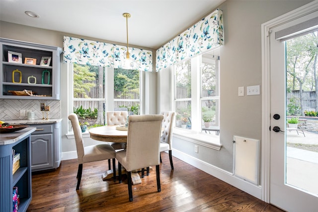 dining area featuring baseboards and dark wood finished floors