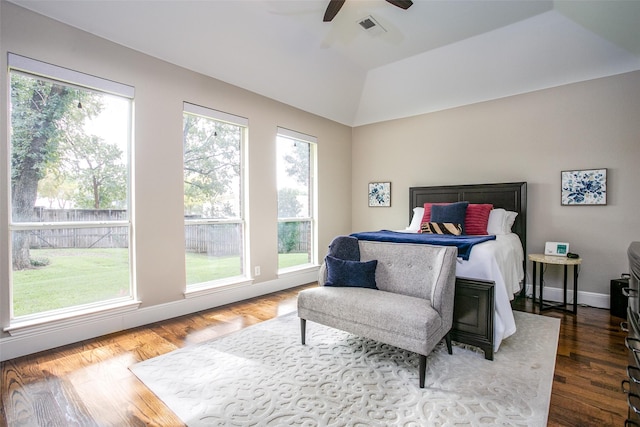bedroom with multiple windows, wood finished floors, vaulted ceiling, and a ceiling fan