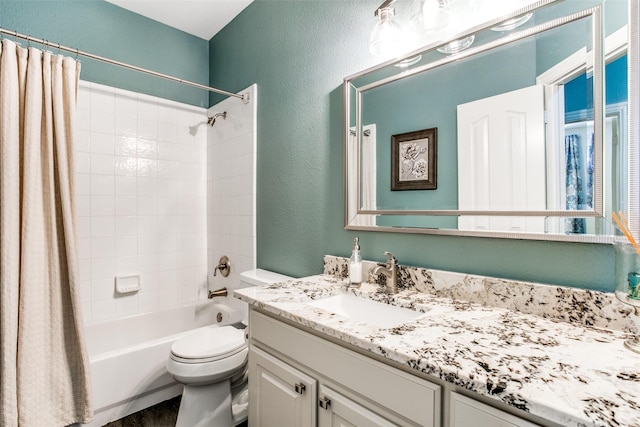 full bath with toilet, vanity, shower / bath combo, a textured wall, and wood finished floors