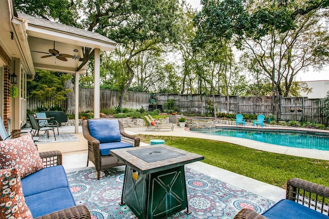 view of patio / terrace with ceiling fan, a fenced backyard, and a fire pit