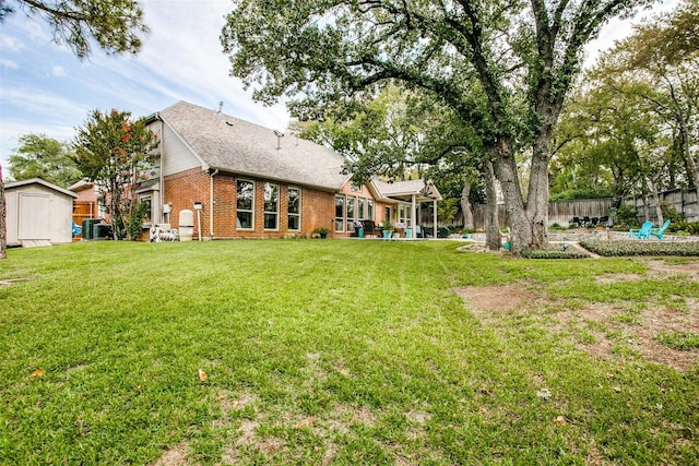 view of yard with a storage shed, an outdoor structure, central AC, and a patio
