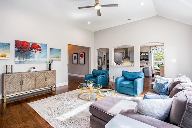 living area featuring arched walkways, ceiling fan, wood finished floors, recessed lighting, and baseboards