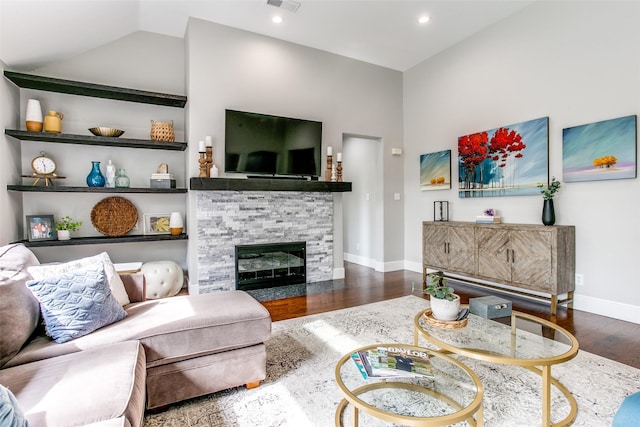 living room with baseboards, wood finished floors, a fireplace, recessed lighting, and high vaulted ceiling