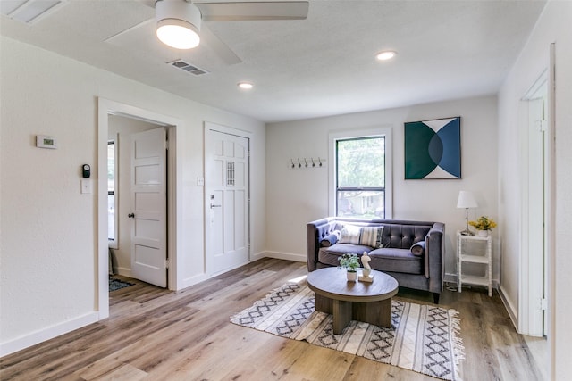 living area with wood finished floors, ceiling fan, baseboards, and recessed lighting
