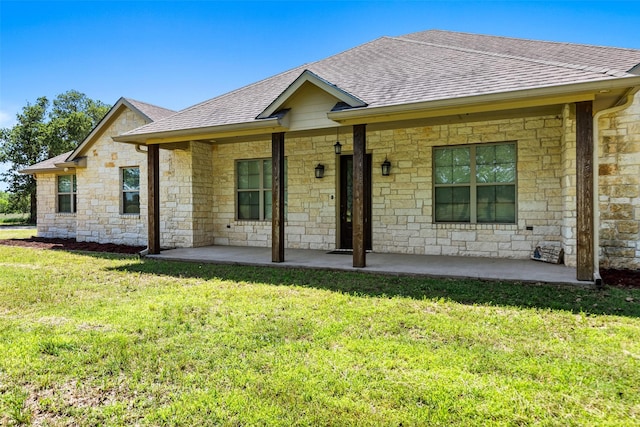 2743 Tokio Rd, West, TX 76691 - single story home featuring a shingled roof, stone siding, a front yard, and covered porch