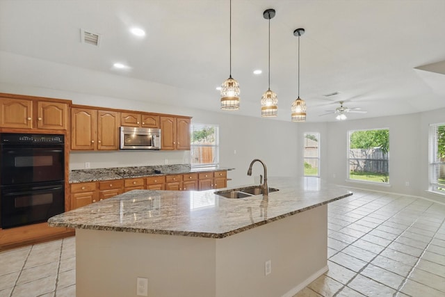 301 Angela Dr, Burleson, TX 76028 - kitchen featuring a sink, black appliances, light tile patterned floors, light stone counters, and recessed lighting