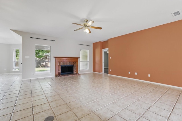 301 Angela Dr, Burleson, TX 76028 - unfurnished living room featuring light tile patterned floors, ceiling fan, a fireplace, and baseboards