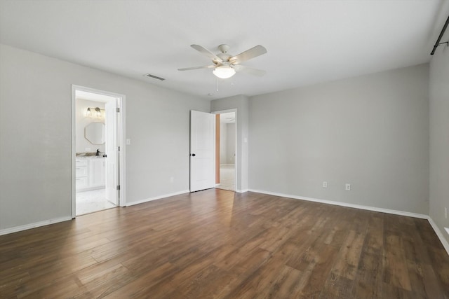 301 Angela Dr, Burleson, TX 76028 - unfurnished bedroom with dark wood-type flooring, baseboards, ceiling fan, and connected bathroom