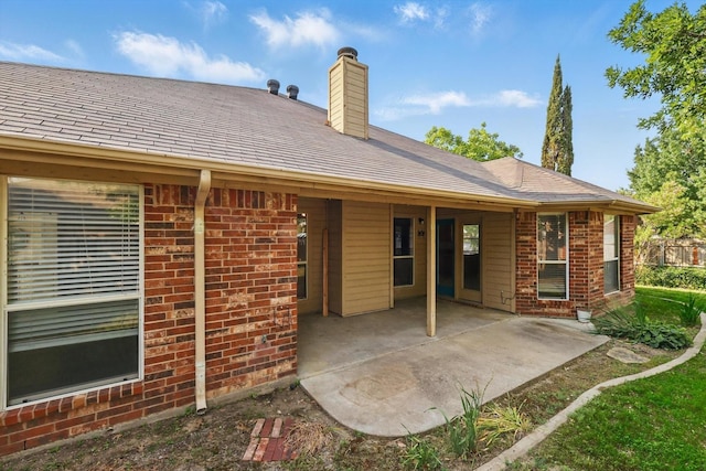 301 Angela Dr, Burleson, TX 76028 - rear view of house featuring brick siding, a patio area, and a chimney