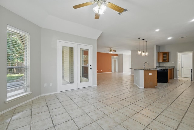 301 Angela Dr, Burleson, TX 76028 - kitchen with open floor plan, a ceiling fan, light tile patterned flooring, black dishwasher, and brown cabinets