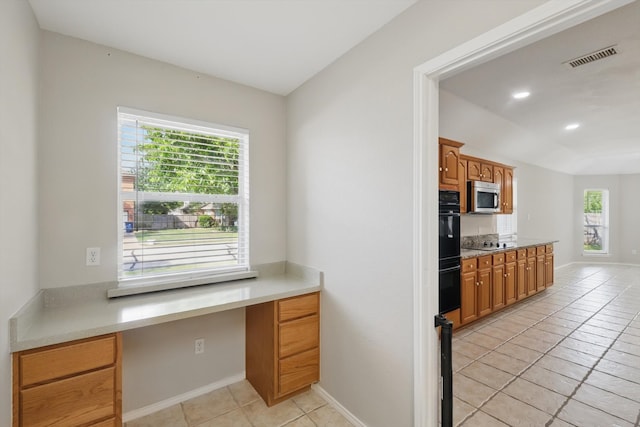 301 Angela Dr, Burleson, TX 76028 - kitchen with stainless steel microwave, light tile patterned floors, light countertops, and recessed lighting