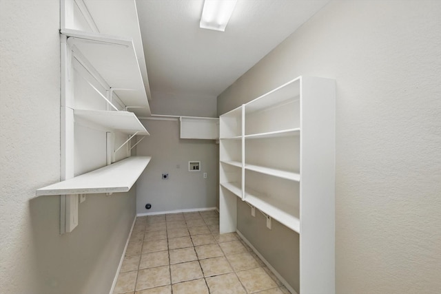 301 Angela Dr, Burleson, TX 76028 - laundry room featuring hookup for an electric dryer, washer hookup, light tile patterned floors, and baseboards