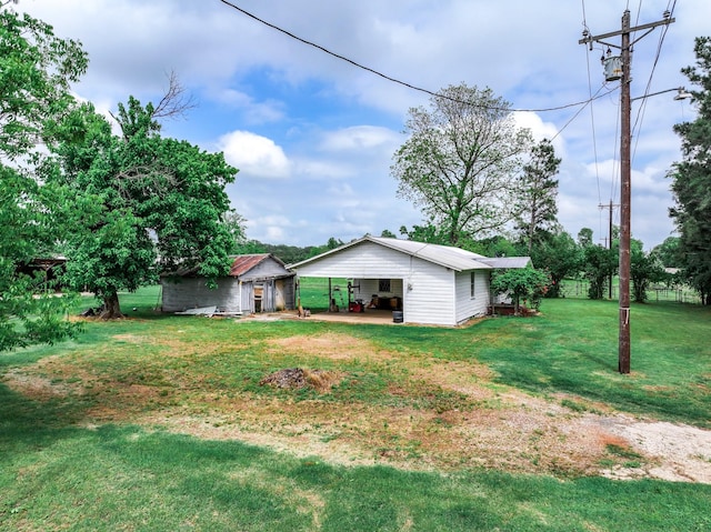 14581 Texas Highway 11 E, Pickton, TX 75471 - view of green lawn featuring an outdoor structure and a carport