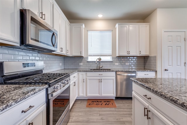 5616 Apple Grove Way, Fort Worth, TX 76123 - kitchen with appliances with stainless steel finishes, a sink, white cabinets, stone countertops, and recessed lighting