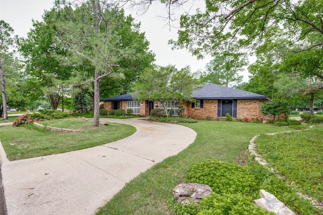 2500 Shoreline Dr, Sherman, TX 75092 - ranch-style home with brick siding, a front lawn, curved driveway, and roof with shingles