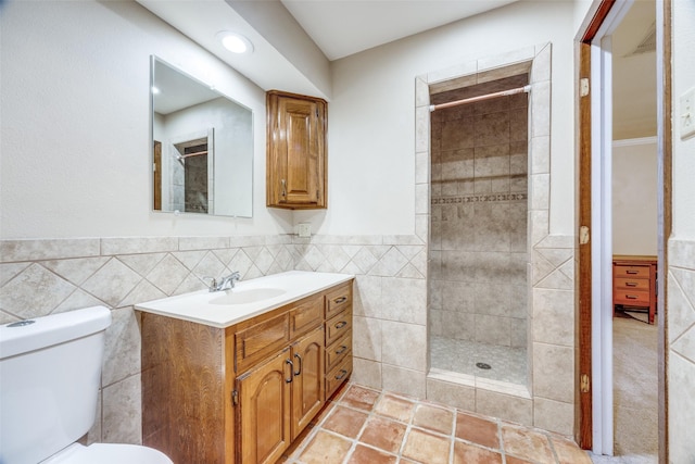 2500 Shoreline Dr, Sherman, TX 75092 - full bathroom featuring tile walls, tiled shower, vanity, toilet, and wainscoting