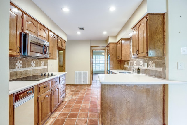 2500 Shoreline Dr, Sherman, TX 75092 - kitchen featuring stainless steel microwave, black electric cooktop, decorative backsplash, light countertops, and recessed lighting
