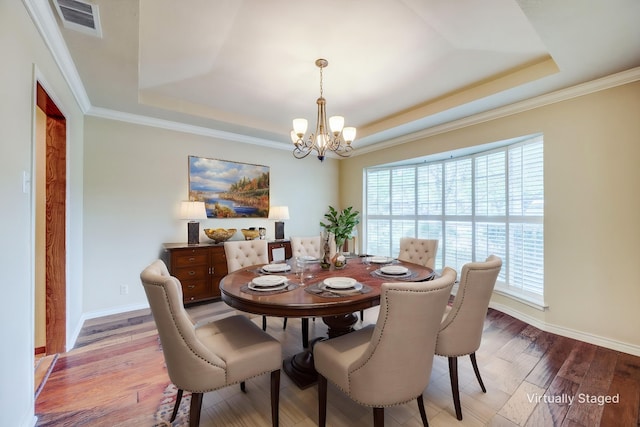 2500 Shoreline Dr, Sherman, TX 75092 - dining space featuring a raised ceiling, a chandelier, healthy amount of natural light, light wood-style floors, and ornamental molding