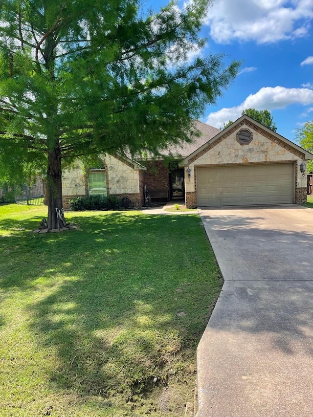 305 W Trunk St, Crandall, TX 75114 - view of front of house featuring concrete driveway, brick siding, an attached garage, and stone siding