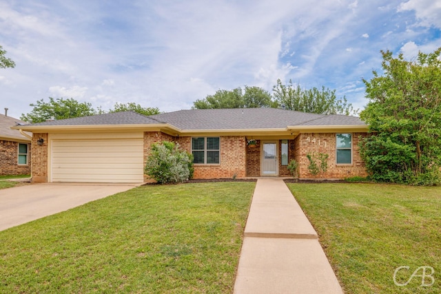 4417 Pamela Dr, Abilene, TX 79606 - ranch-style house featuring brick siding, a garage, a front yard, and driveway