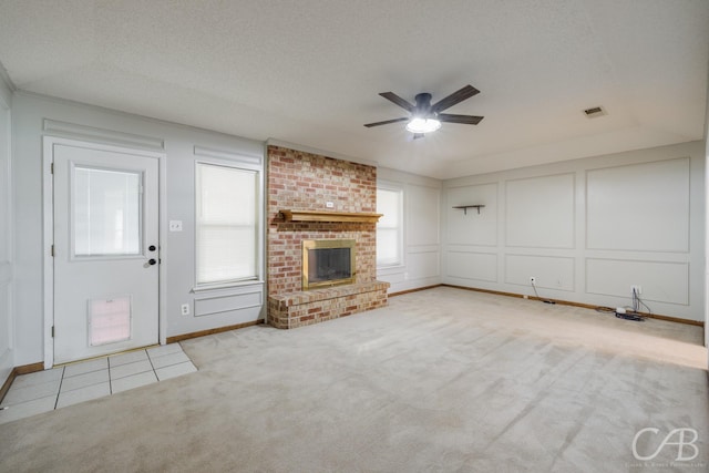 4417 Pamela Dr, Abilene, TX 79606 - unfurnished living room featuring a ceiling fan, a decorative wall, carpet, a textured ceiling, and baseboards