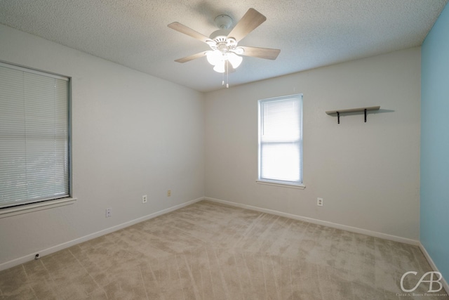 4417 Pamela Dr, Abilene, TX 79606 - spare room featuring light carpet, ceiling fan, baseboards, and a textured ceiling