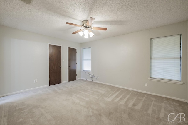 4417 Pamela Dr, Abilene, TX 79606 - unfurnished bedroom featuring light carpet, baseboards, ceiling fan, and a textured ceiling