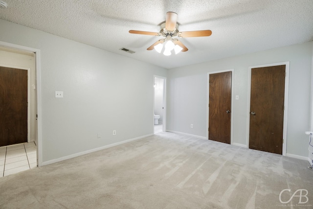 4417 Pamela Dr, Abilene, TX 79606 - unfurnished bedroom with carpet flooring, connected bathroom, multiple closets, baseboards, and a textured ceiling