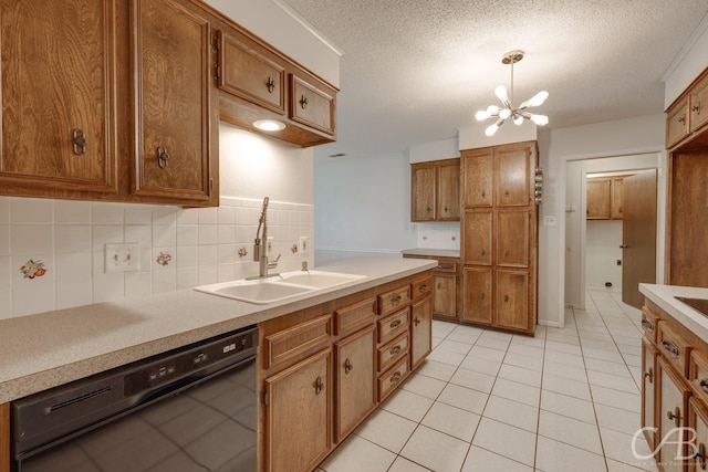 4417 Pamela Dr, Abilene, TX 79606 - kitchen with black dishwasher, a sink, brown cabinetry, and a textured ceiling