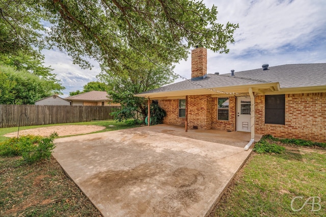 4417 Pamela Dr, Abilene, TX 79606 - rear view of property with a chimney, a patio, brick siding, and a shingled roof