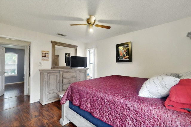 805 Loganwood Dr, Royse City, TX 75189 - bedroom featuring wood finished floors, a ceiling fan, a textured ceiling, and baseboards