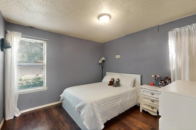 805 Loganwood Dr, Royse City, TX 75189 - bedroom featuring wood finished floors, a textured ceiling, and baseboards